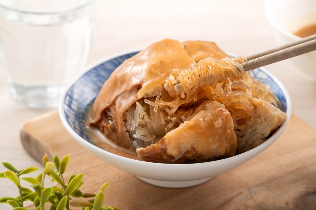 Tamsui agei age aburaage ageh delicious street food in Taiwan stuffed with mung bean noodles and sauce topping 2